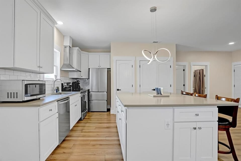 A spacious kitchen island offers plenty of room for cooking or casual dining.