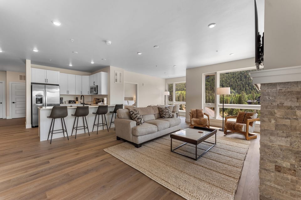 The living area features an electric fireplace, air conditioning, a queen sleeper sofa, and access to the balcony.