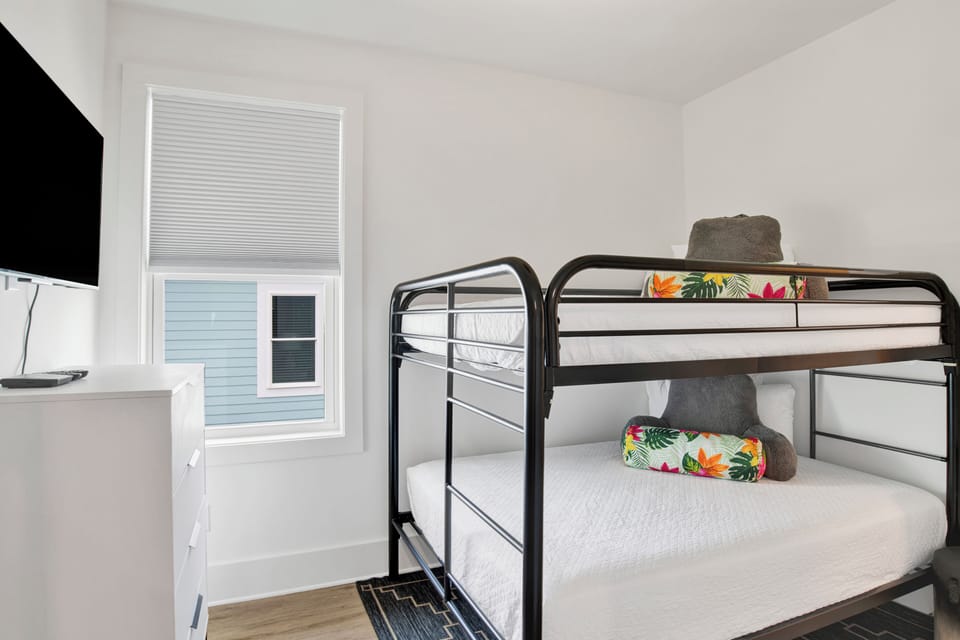 Bedroom 8 has a shared bathroom, TV and Full over Full bunk bed, sleeps 4