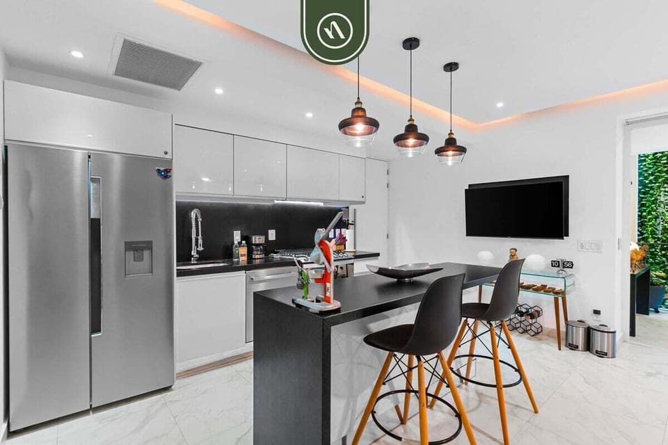 The kitchen is designed for functionality within a compact, modern space, offering everything needed for a comfortable stay