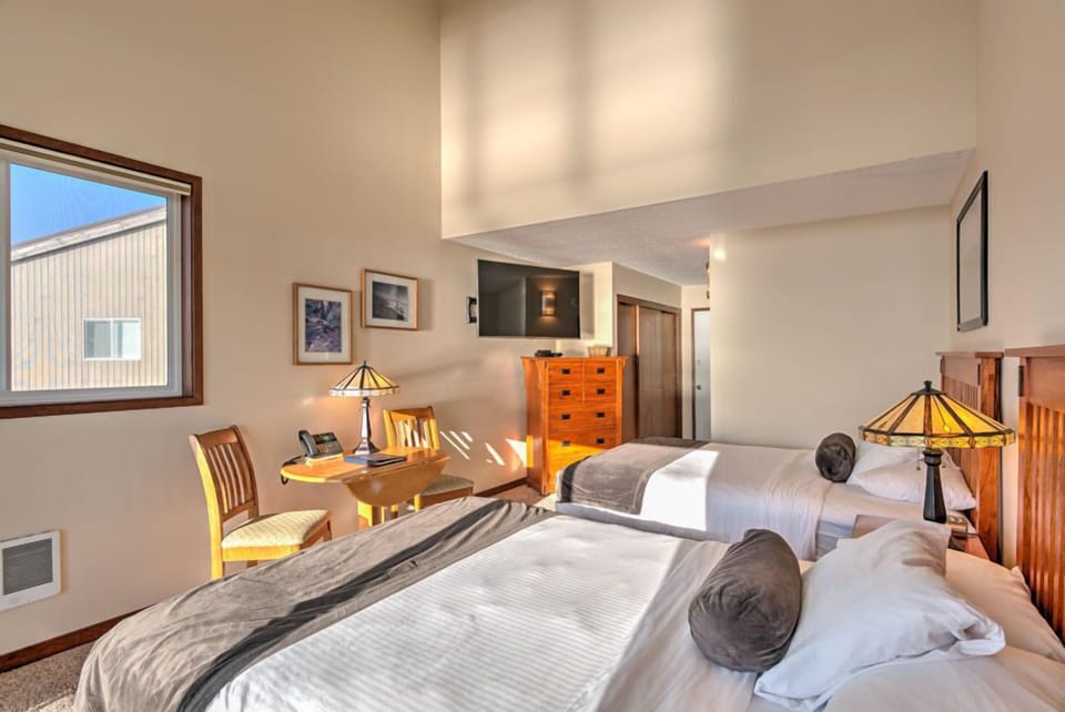 This spacious 2 Queen Bedroom features two comfortable queen beds set in a bright and airy space.