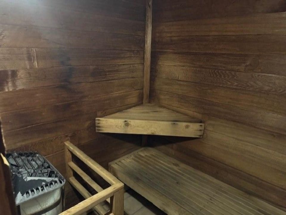 Unwind in the cozy wooden sauna, offering a warm and tranquil retreat after a day of exploring the scenic coastal landscape.
