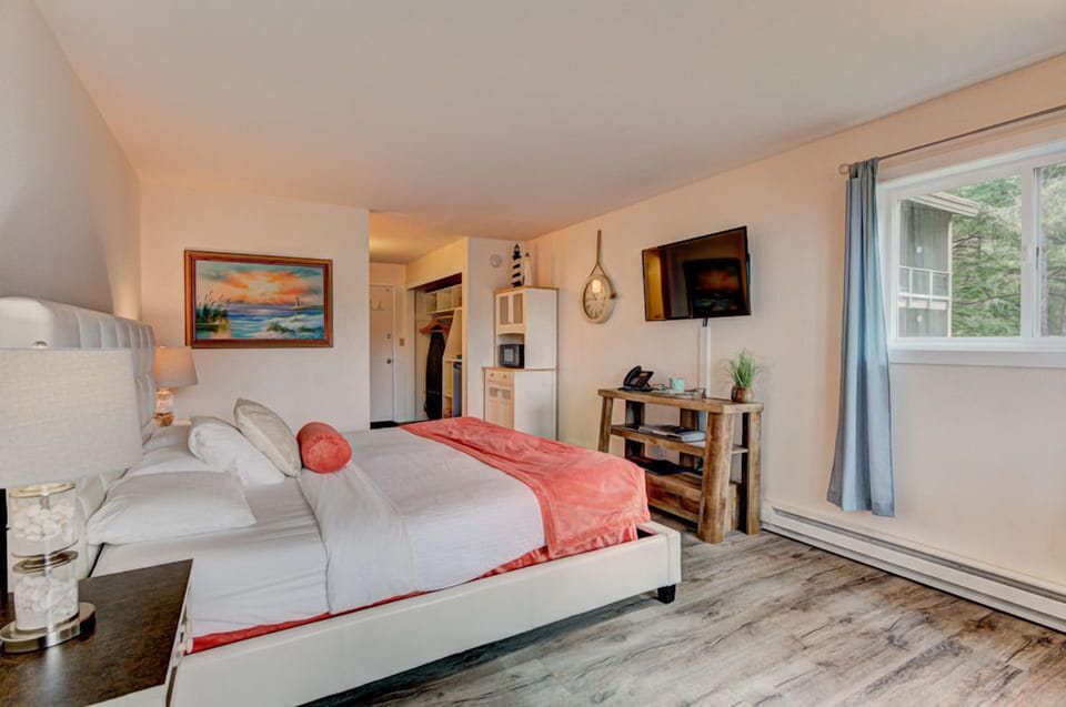 The inviting bedroom features warm coastal décor and a comfortable king bed for a restful stay.