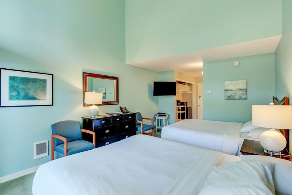 Designed for relaxation, this room includes two queen beds and a comfortable sitting area, perfect for a restful getaway in nature.