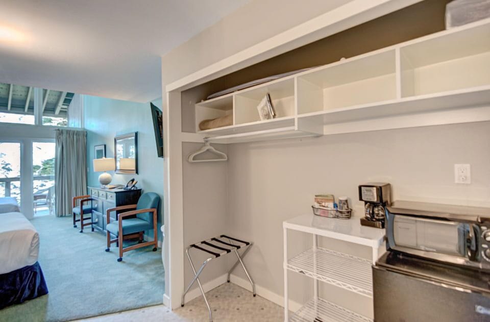 A glimpse of the closet space complements the welcoming ambiance of this Forest View 2 Queen Bedroom, highlighting the convenient amenities of this inviting accommodation.