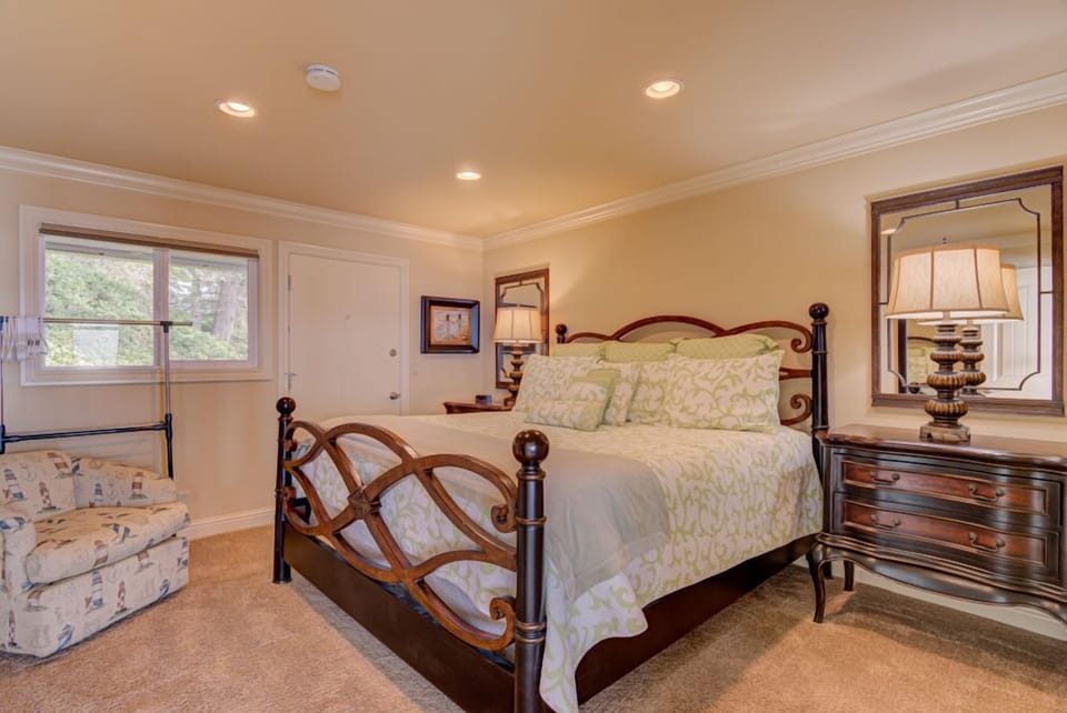 Relax in the elegantly decorated king bedroom that features ample natural light and a serene ambiance, making it a perfect retreat.