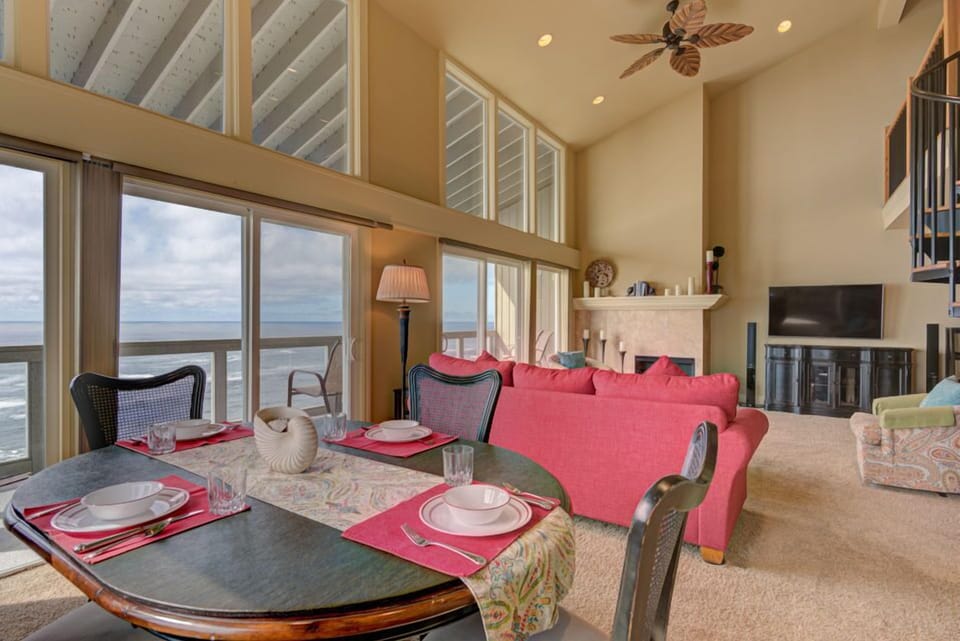 Dine in style with stunning ocean vistas in the dining area, easily accessible from the inviting living room that features plush seating and a warm atmosphere.