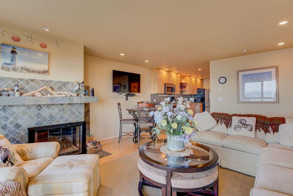 The inviting living room offers a perfect spot to relax, with its stylish furnishings and an open layout that connects to the dining area.