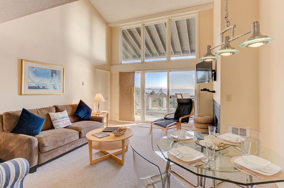 Natural light floods the living area, revealing stunning ocean vistas and a welcoming setup, perfect for relaxation or entertaining.