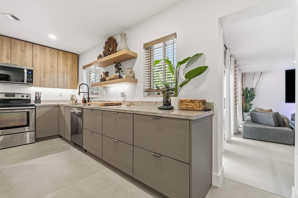 Here, the layout speaks for itself—wrapped quartzite, warm cabinetry, and curated artisan décor leading directly into the media room. A seamless, stay-connected flow that blends cooking, lounging, and gathering in one grounded, modern space.