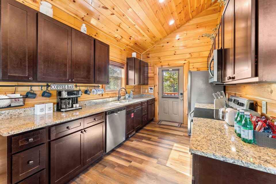 [Kitchen] Entering the cabin you'll find a bright, fully stocked kitchen with everything you need for meals at home. You'll enjoy the full coffee bar with Keurig combo (pot and pods).