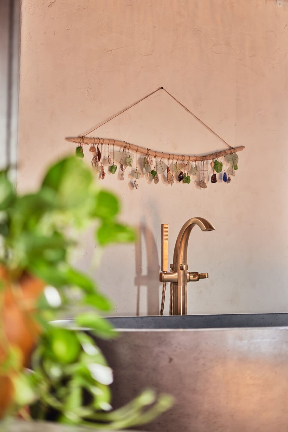 The intricate details of this luxurious bath area are enhanced by a unique decorative hanging, creating a tranquil escape.