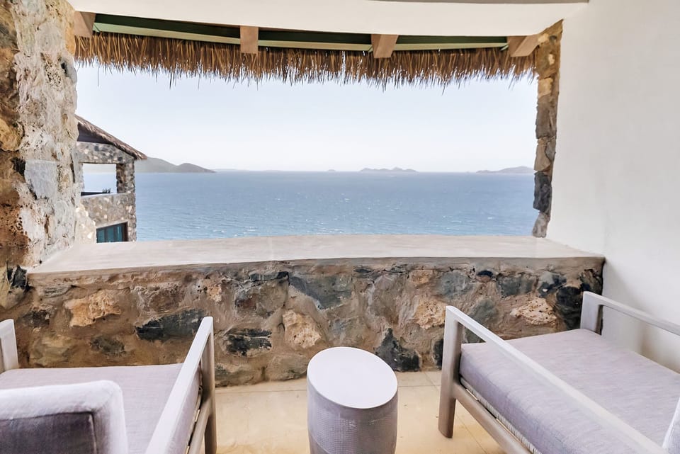 Relax with panoramic views from this charming stone-built terrace, complete with cozy seating.