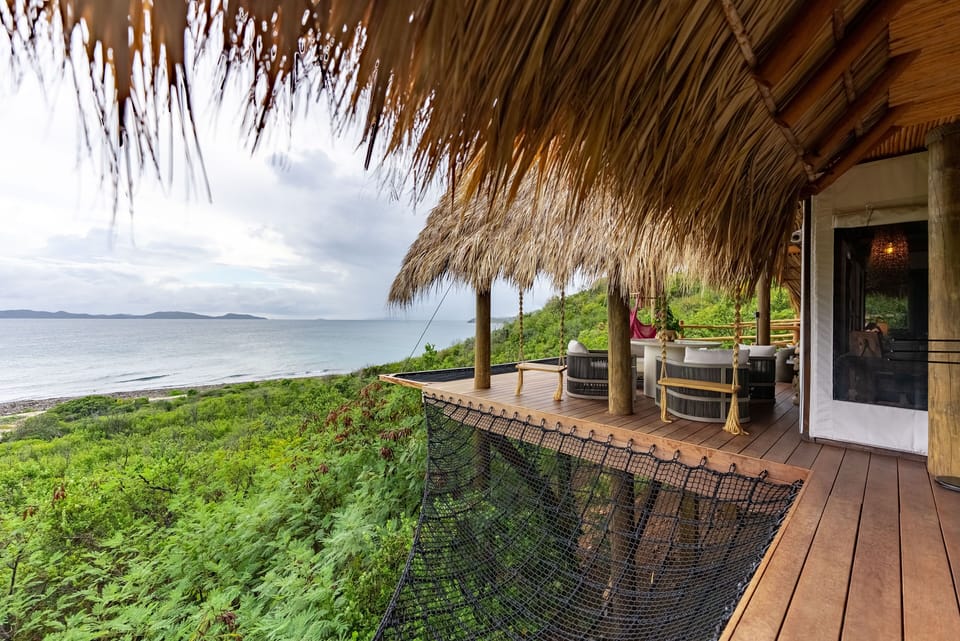 Reconnect with nature on your expansive deck, where sweeping ocean views and cozy stargazing nets create the ultimate backdrop for unforgettable moments in paradise.