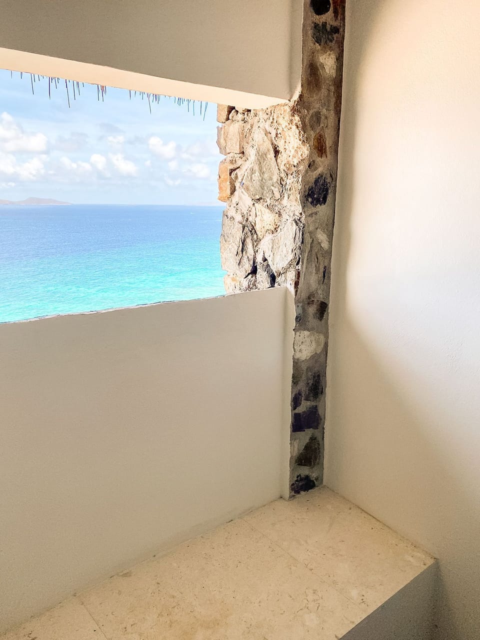 Admire panoramic sunset ocean views through this unique window in the shower, connecting you to the beauty of the Carribean.