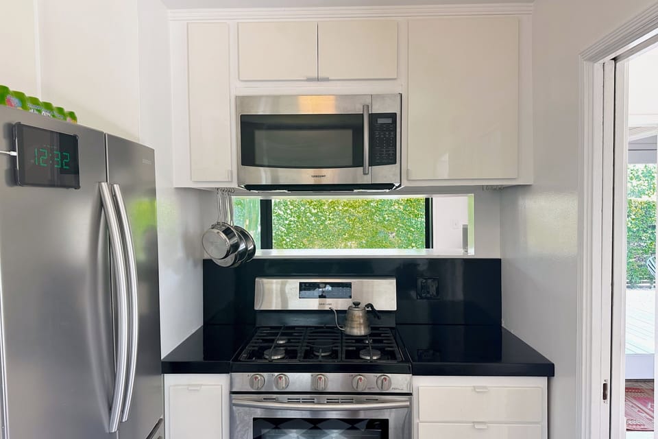 Looking thru kitchen over stove into living room space.