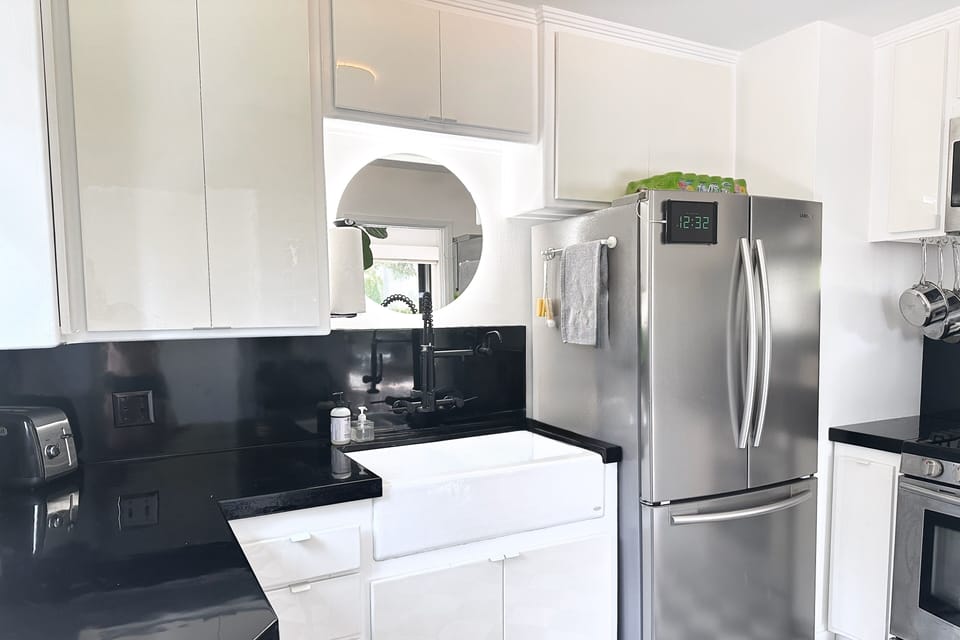 Updated kitchen with black epoxy countertops.