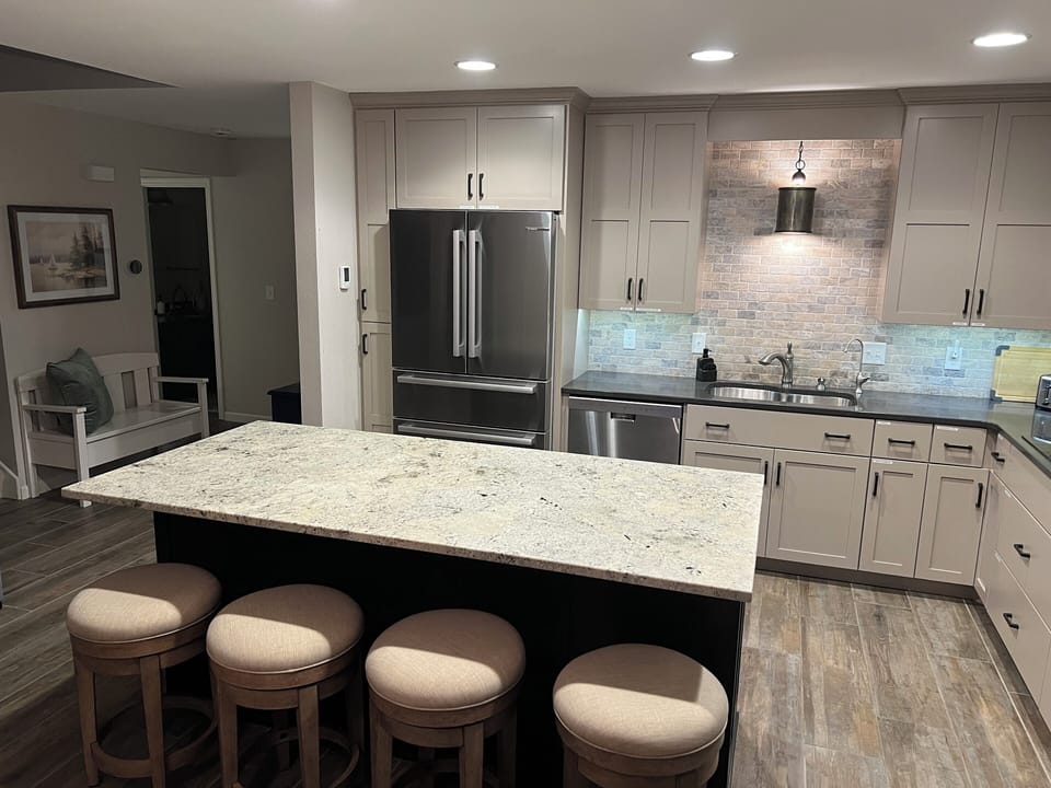 Main level kitchen, fully equipped with SS appliances, dishes, and cooking items