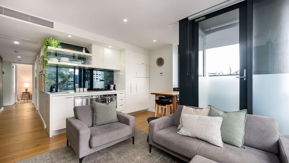 Open plan living with access to small step on balcony space