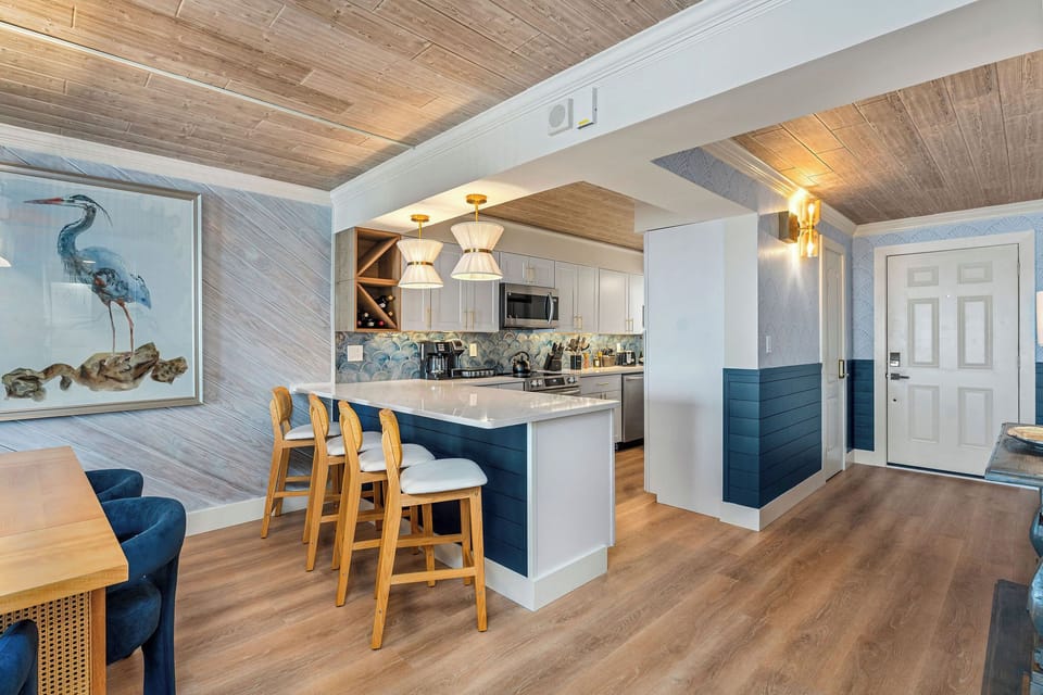 Open-concept layout with breakfast bar & designer finishes