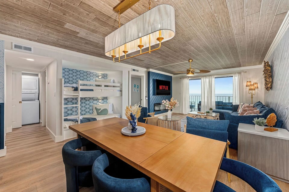 Cook, dine, and unwind in style — this open-concept kitchen and dining area features chic lighting, modern finishes, and stunning ocean views that bring the beach right into your home.