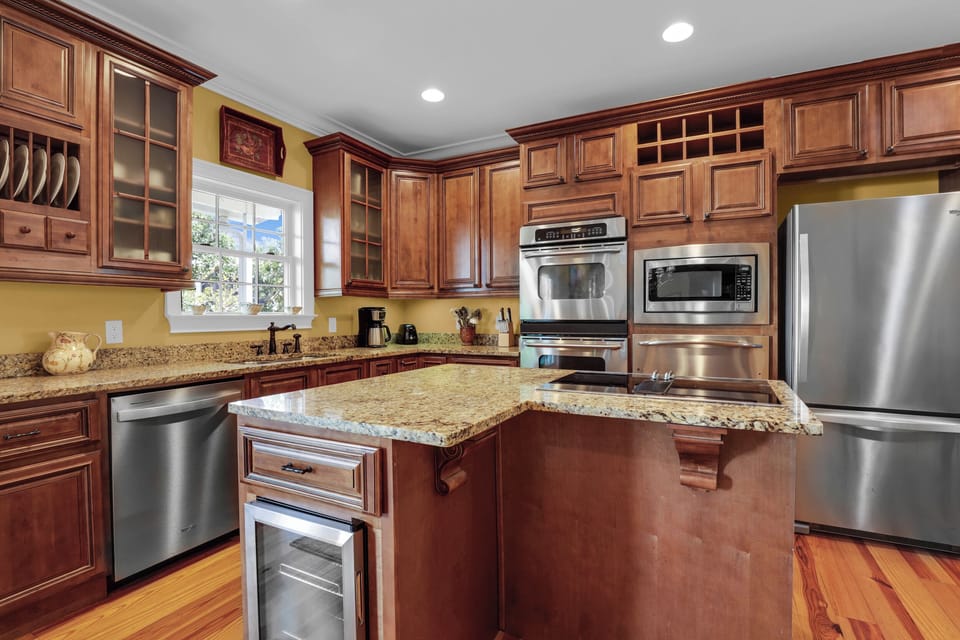 The kitchen has built-in appliances and ample room for any chef