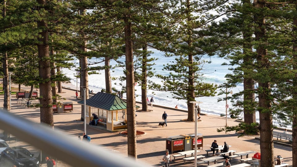  Elevated balcony perspective overlooking the vibrant beachfront below.