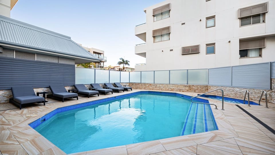 Resort-style swimming pool with sun loungers for laid-back afternoons.