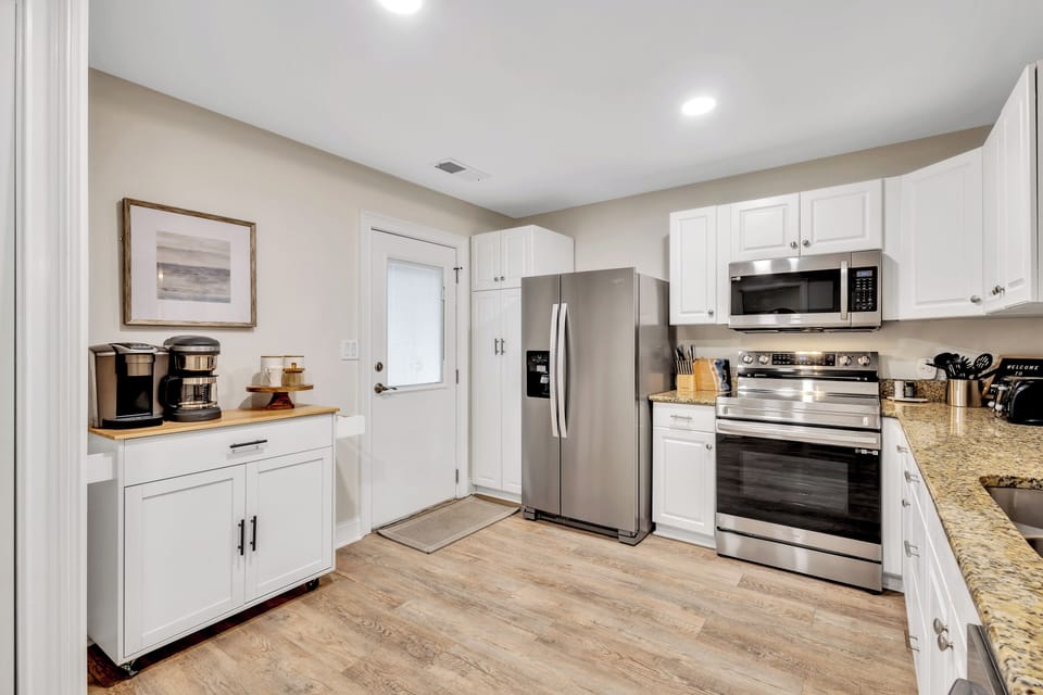 The sleek, fully equipped kitchen is designed for everything from quick breakfasts to gourmet dinners