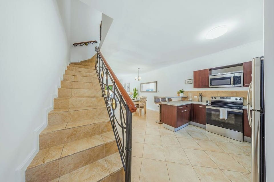 The staircase is positioned perfectly to maintain a bright, open feeling on the main floor, overlooking the dining area.