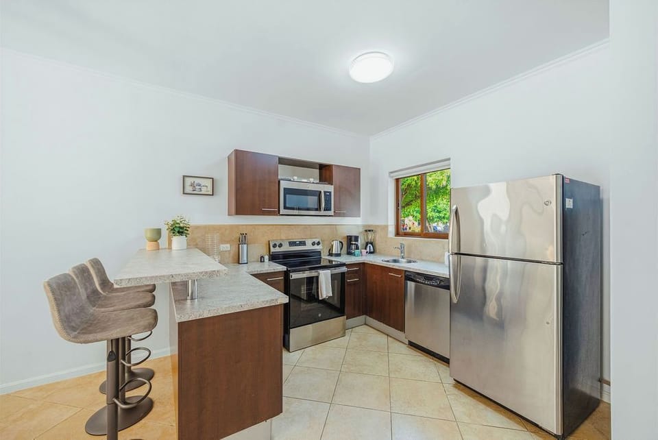 Fully equipped kitchen with appliances, ample counter space, and modern finishes—ideal for preparing family meals or group dinners with ease.