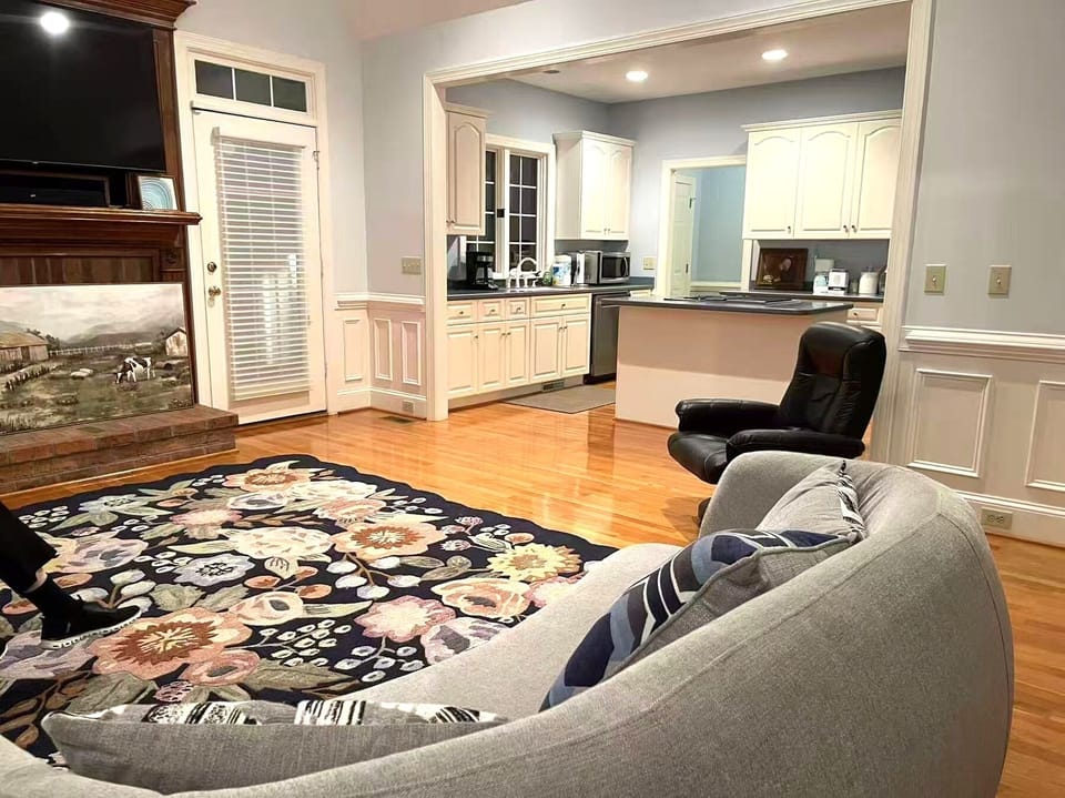 Elegant living area with cozy seating and floral area rug