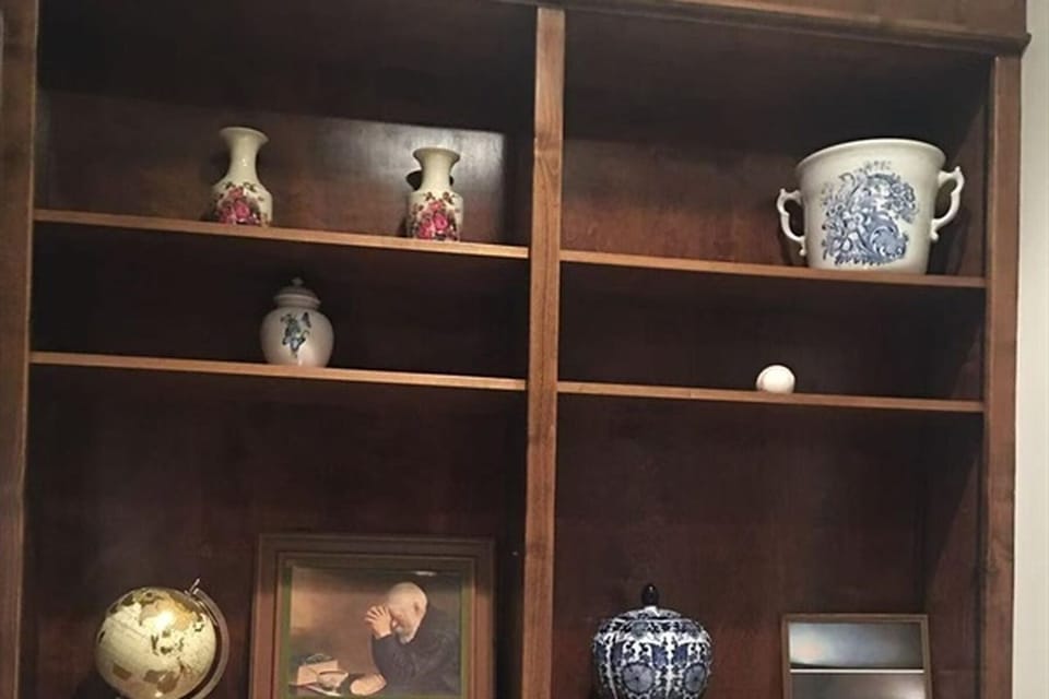 Classic wooden bookshelf with art pieces and vintage décor
