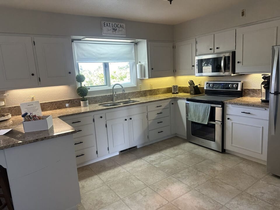 Well-equipped kitchen featuring a double oven, ample counter space, and modern appliances.