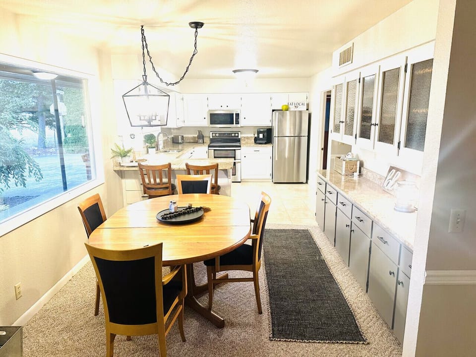 Open dining area featuring an expandable table that comfortably seats up to 8 guests.
