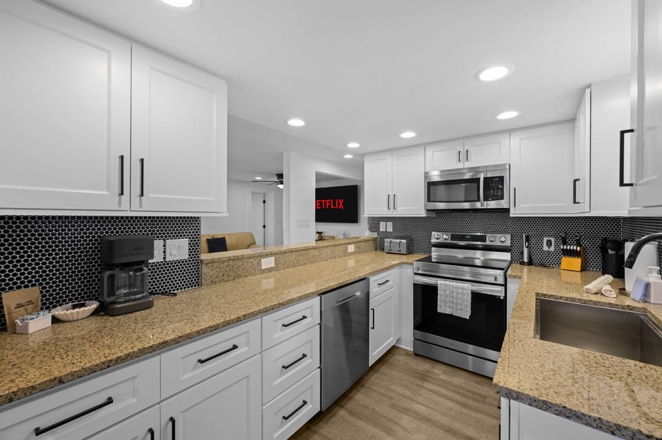 Your inner chef is calling! This kitchen is ready for your culinary creations. Whether you're brewing a fresh pot of coffee or cooking a gourmet meal, the stylish and functional space makes it a breeze.