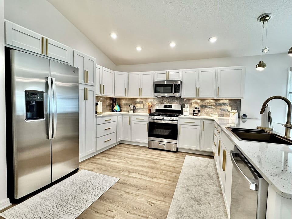 Completely Redone Kitchen with Stunning Backsplash and Striking Accent Lights!
