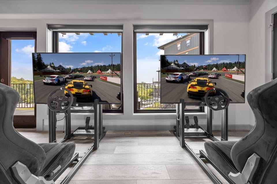Challenge a friend to a thrilling race in the dual racing simulator setup, complete with full driving rigs and immersive screens—perfect for gamers and thrill seekers alike.