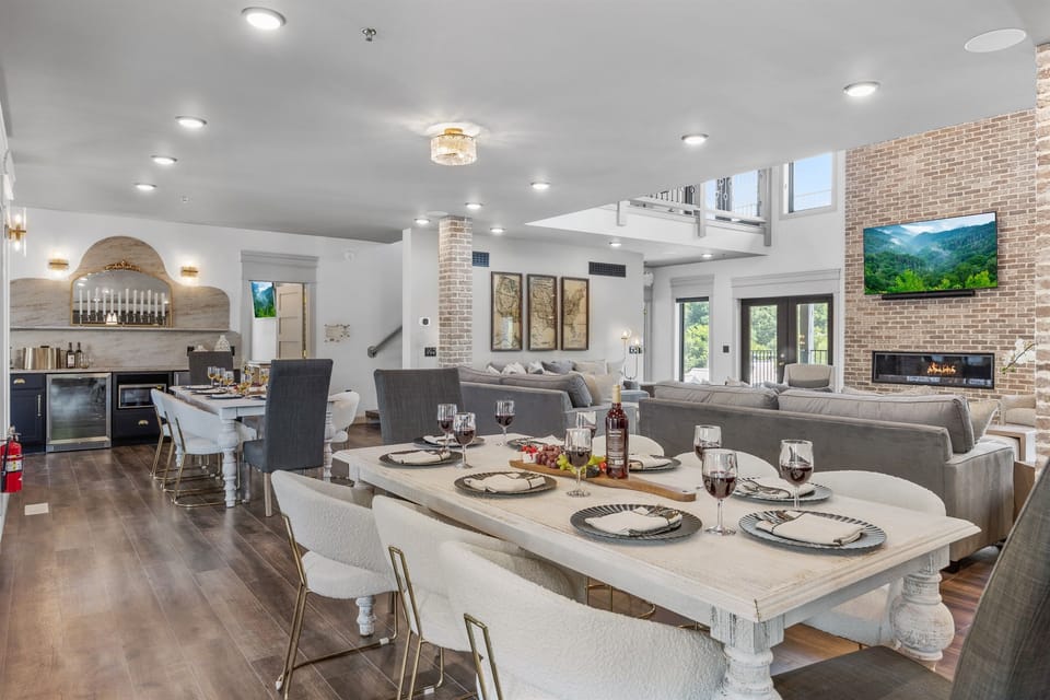 Enjoy open-concept living with this luxurious dining and lounge area. Featuring plush seating, a modern fireplace, and stylish decor, it's perfect for entertaining guests or enjoying relaxed family dinners in a beautifully lit setting.