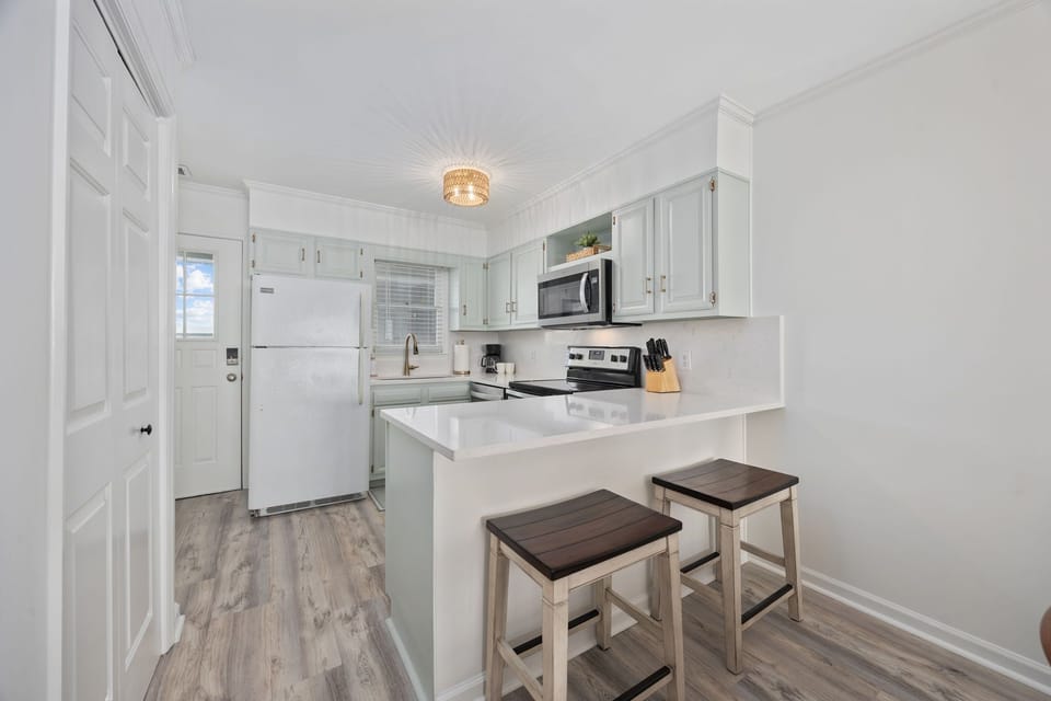 Modern kitchen featuring a convenient breakfast bar with seating for two.
