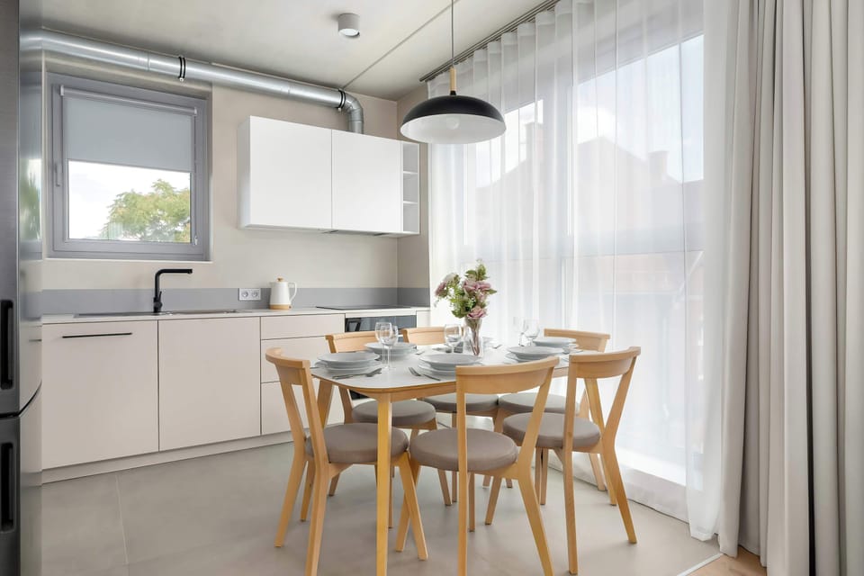 The dining area by the window opens up to greenery, making every meal feel truly special.