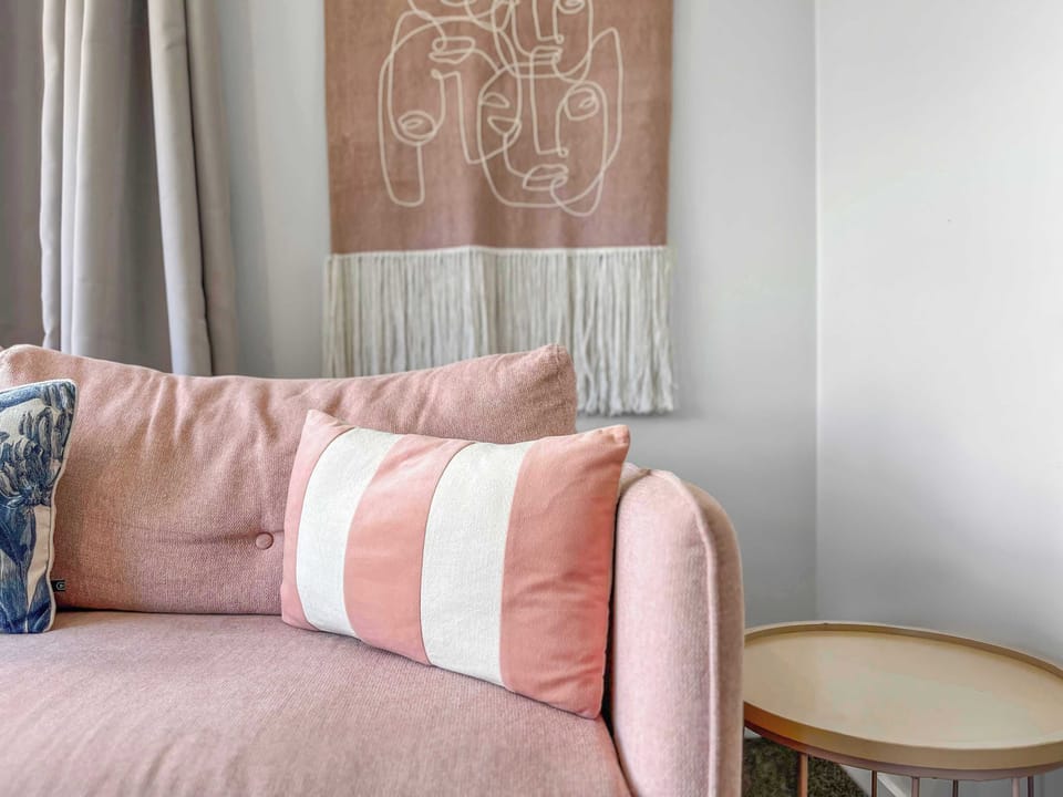 Soft furnishings and curated artwork add warmth and character to the living space.