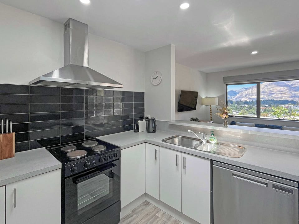 Modern, fully equipped kitchen with sleek finishes and beautiful mountain views to enjoy while you cook.