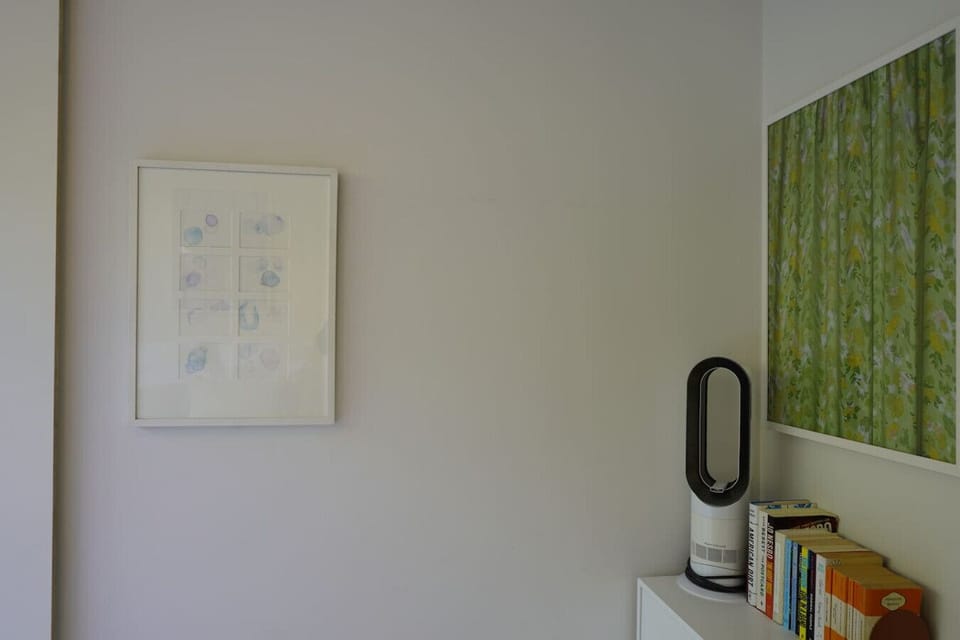 There is a book corner and airfan in the corner of the bedroom.
