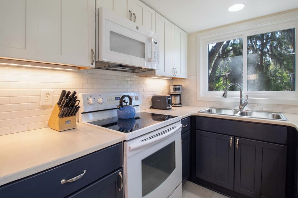 You'll love preparing meals in this bright, fully-equipped kitchen with modern appliances and beautiful natural light streaming in.