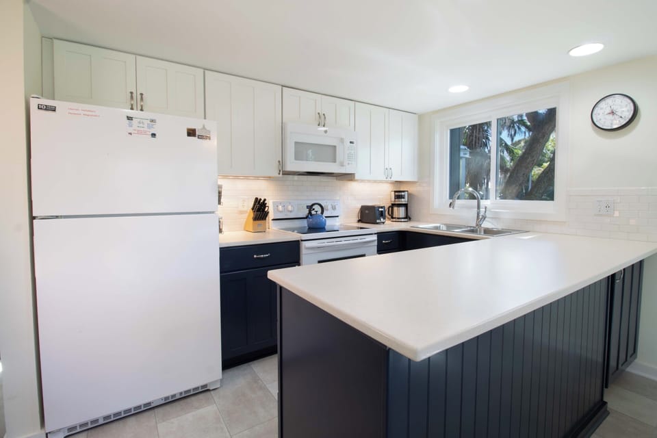 Whip up your favorite meals in this spacious kitchen featuring modern appliances and plenty of counter space for cooking together.