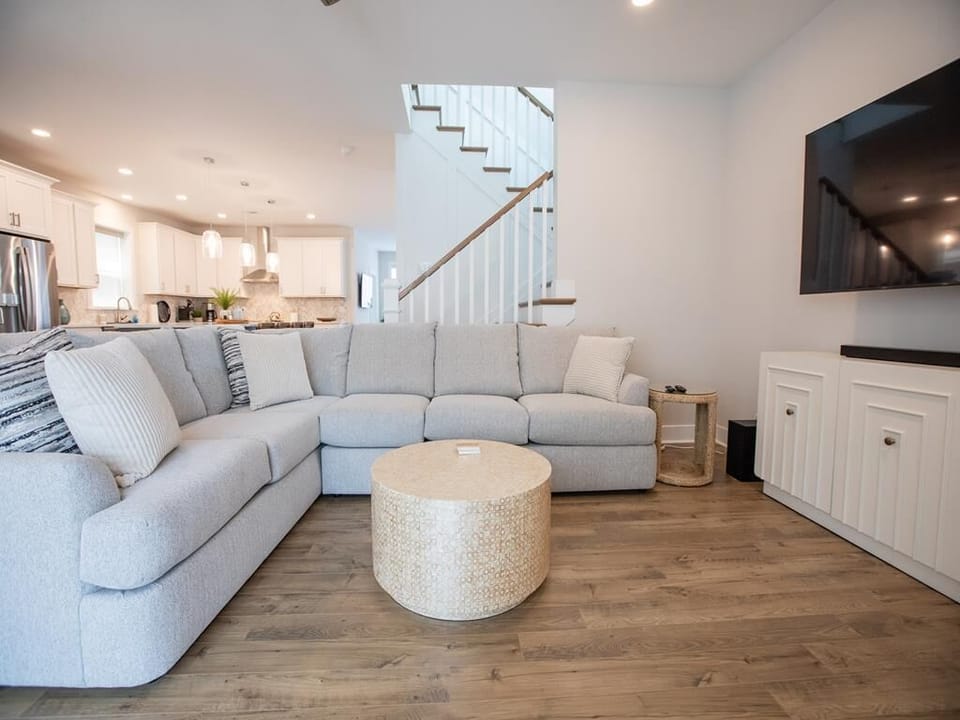 Comfortable main living area with sectional sofa and smart TV for cozy nights in.