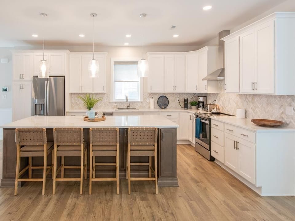 Spacious kitchen with large island and seating for four—ideal for entertaining or family breakfasts.