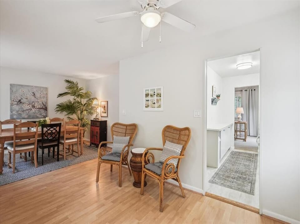 Entry hallway with sitting area and warm wood flooring welcomes you into the home.