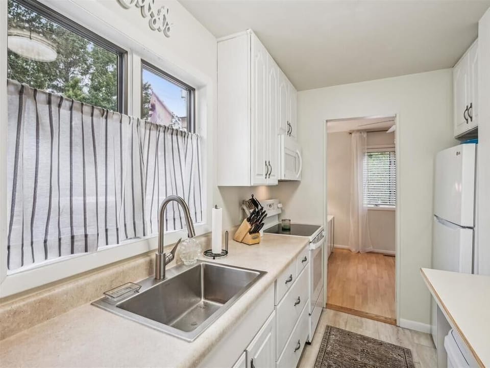 Bright kitchen with dual sinks and garden views for a pleasant meal prep experience.